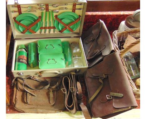 Three vintage leather satchels together with a vintage cased picnic set to include a Thermos flask with other related accesso