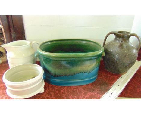 An unusual foot bath type two handled planter of oval form with streaked and mottled green glaze on a turquoise ground togeth