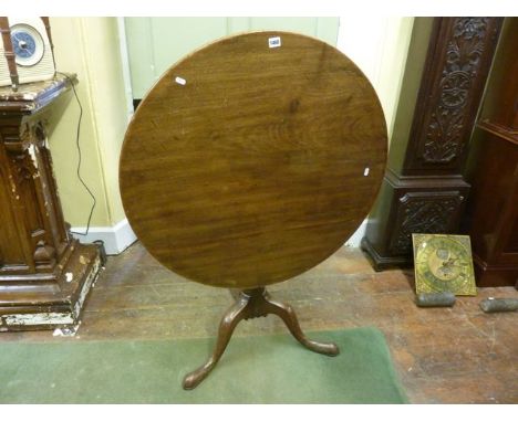 A Georgian mahogany snap top table, the circular top 88cm in diameter, raised on a turned pillar and tripod base 