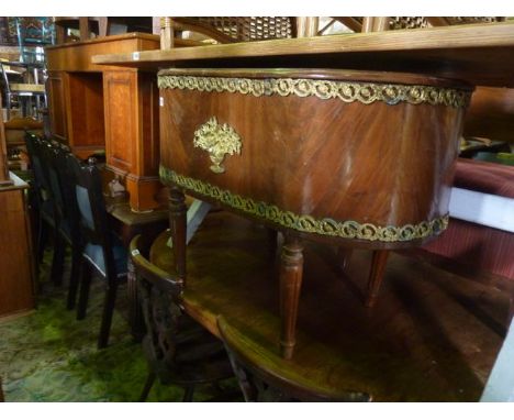 A reproduction freestanding French wine cooler/planter of oval form, tin/zinc lined with applied gilt cast metal mounts raise