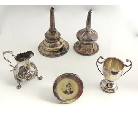 A Victorian silver creamer, Daniel & Charles Houle, London, 1861, the bulbous body chased with floral bouquets on three shell