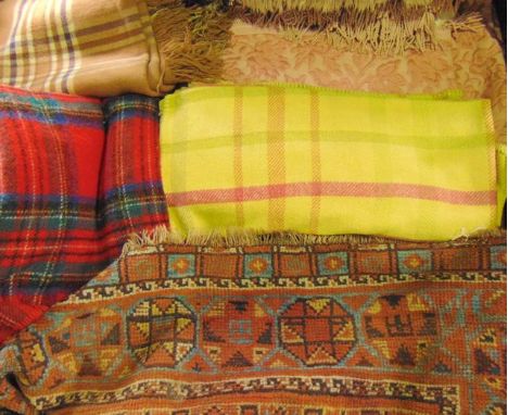 An eastern wool work rug with ochre ground and geometric detail together with a vintage embroidered bed throw with pink folia