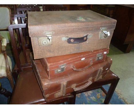 Three vintage suitcases of varying size to include a simulated crocodile skin example
