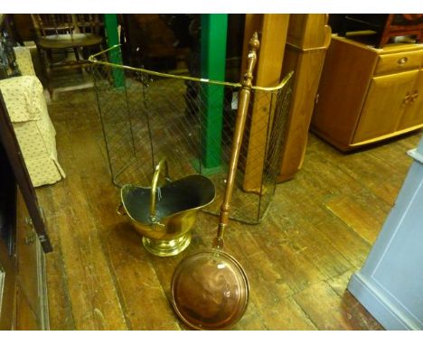 A Victorian wirework nursery fender with brass rail top, a brass coal helmet and a copper warming pan