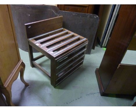 A vintage oak framed drop leaf extending luggage rack with open slatted top with applied metal strips, labelled to back Warin