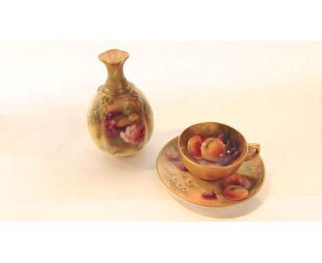 A Royal Worcester miniature cabinet cup and saucer with painted fruit decoration to the interior of the cup and saucer incorp