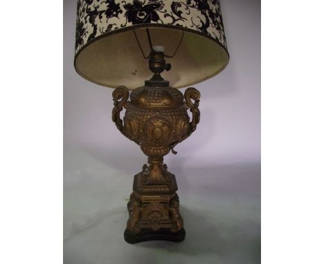 A decorative 19th century desk lamp with all over gilded finish, the urn shaped bowl with scrolling acanthus clad handles rai