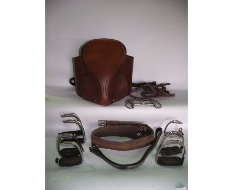 A vintage tan leather side saddle complete with a quantity of further related equine tackle to include stirrups, etc
