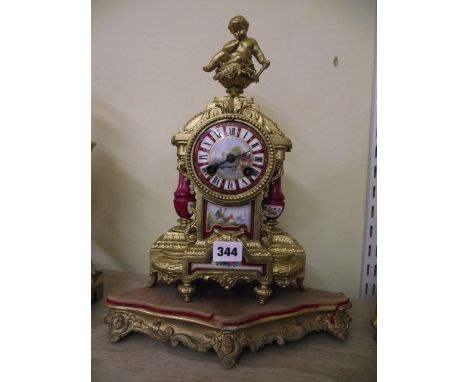 A 19th century gilt spelter mantle clock with hand painted porcelain dial and inset panels with eight day striking movement, 