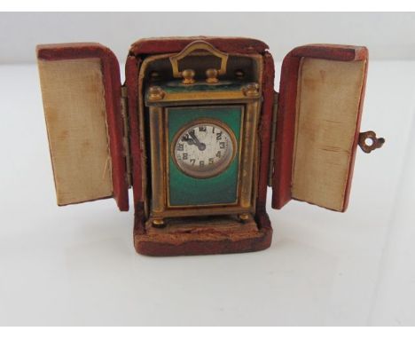 A miniature carriage clock, Lira Watch Co., the silvered dial with Arabic numerals, the brass case with green guilloche ename