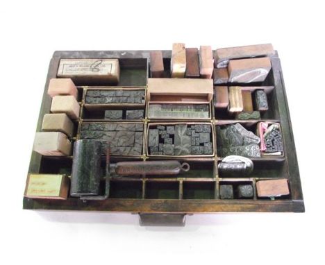 A vintage Scottish timber printing tray with multidivisional interior strengthened with brass fittings containing a mixed qua