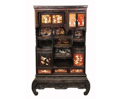 A 19th century Japanese cabinet with carved and pierced detail, fitted with an arrangment of drawers, cupboards and alcoves, 