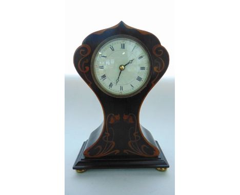 An Art Nouveau mantle clock in mahogany with balloon shaped case and floral marquetry inlay, with convex enamel dial and late
