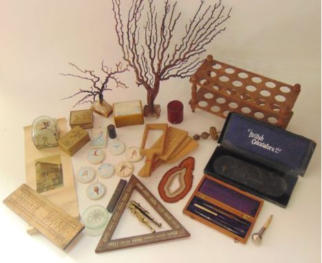 A miscellaneous collection to include an inlaid timber crib triangle, a further crib board, treen butter paddles, a glass bot