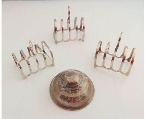 A George V silver ink well, W. H. Haseler Ltd, Birmingham, 1910, of domed circular form, loaded; a pair of silver toast racks