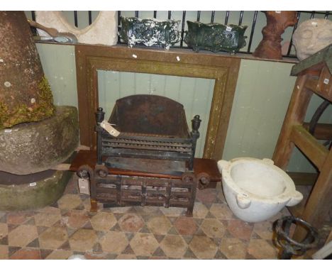 A heavy cast iron fire basket of rectangular form with scrolled finials, one other and a 19th century cast iron fire surround