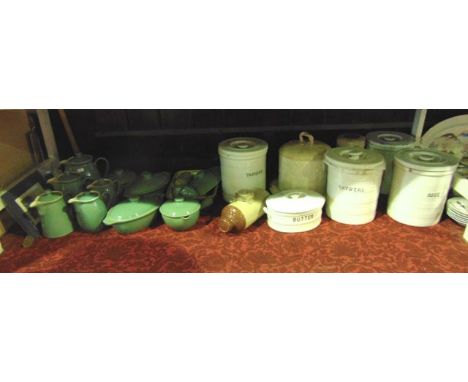A collection of four white glazed ceramic kitchen storage jars and covers of cylindrical form with moulded banded decoration,