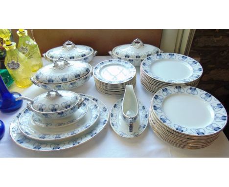A collection of early 20th century blue and white printed Tulip pattern dinner wares with Art Nouveau style border detail com