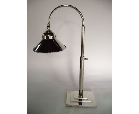 A substantial contemporary silver plated desk lamp on adjustable stem with flared rim raised on a squared stepped base, 57 cm