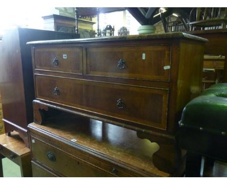 A low reproduction walnut veneered chest in the 18th century style fitted with one long and two short drawers raised on shape