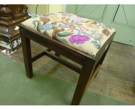 A 19th century mahogany stool of rectangular form with chamfered supports united by an x framed stretcher with hand worked ta