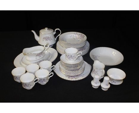 Royal Stafford porcelain dinner and tea service, the white bodies with gilt borders and foliate decoration (qty)