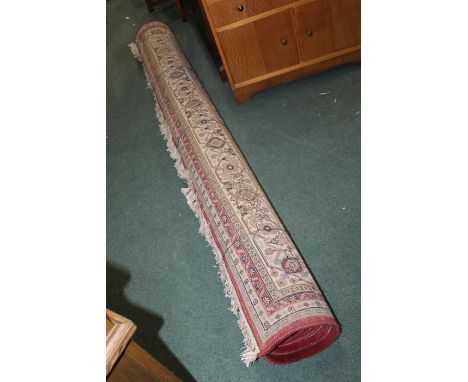 Middle Eastern carpet, the central field with foliate decoration surrounded by multiple borders and tasselled ends, 243cm wid