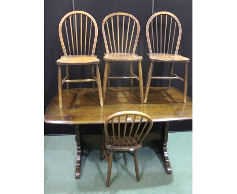 Ercol dark oak refectory style table, on shaped end supports united by a flattened stretcher, together with four matching spi