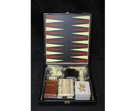 Games compendium, including chess, backgammon, dominoes, playing cards, housed in a folding leatherette case