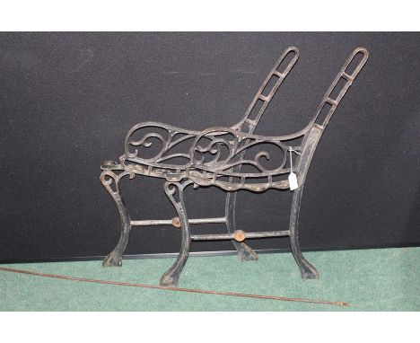 Pair of cast metal bench ends and rod stretcher (3)