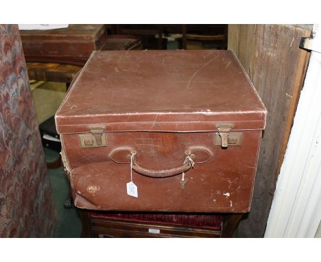 Brown leather trunk, with various travel labels to the exterior and pleated lining to the interior, 50cm square