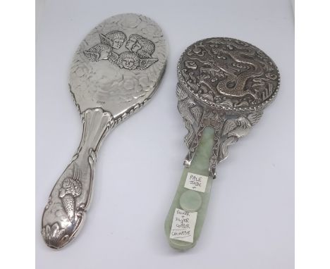 A Chinese pale jade silver on copper hand mirror together with an English hallmark silver and patterned back hand mirror (2)