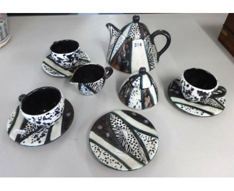 South African Trizia Studio pottery tea service 2003, teapot, cream jug, sugar bowl, three cups and four plates.