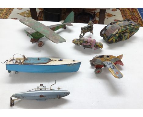 A collection of vintage tinplate toys including aircraft, Japanese clockwork camouflaged motorcycle and rider, German tinplat