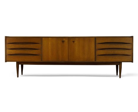 Danish, a teak sideboard in the manner of Arne Vodder    c.1960  With two cupboard doors, enclosing one shelf, flanked by two