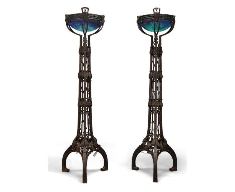 A pair of modern iron and glass uplighter floor lamps in the style of Louis Majorelle Late 20th Century The frosted glass sha