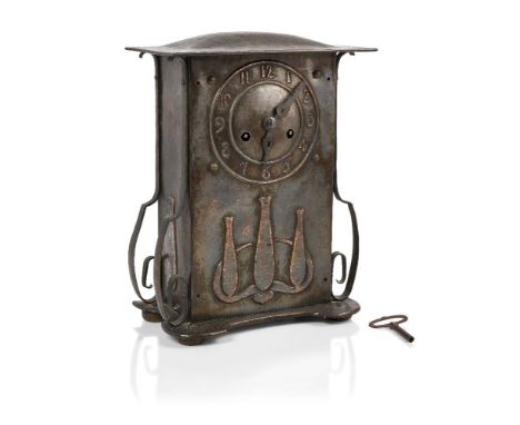 An Arts & Crafts patinated copper and oak mantel clock c.1905 The rectangular form with splayed top embossed on the front wit
