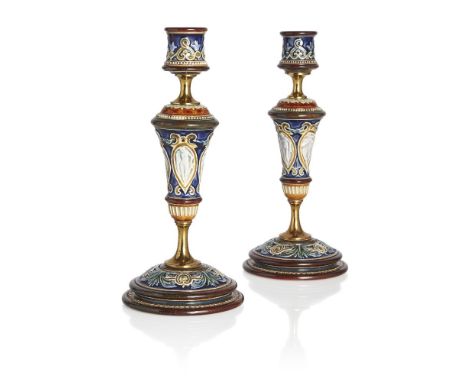 Doulton (British), a pair of Lambeth stoneware candlesticks c.1880-91, makers impressed Rosette mark The sconce and baluster 