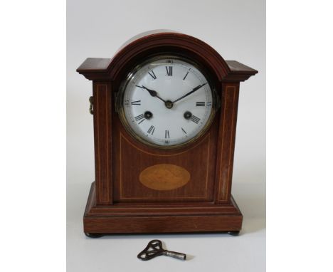 An Edwardian mahogany and inlaid arched cased mantel clock having an enamel dial, height 31cm