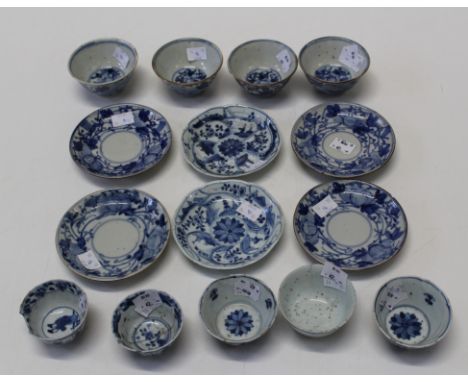 Two similar Chinese blue and white porcelain tea bowls and saucers, Qing Dynasty circa 1740, of lotus moulded shape, painted 