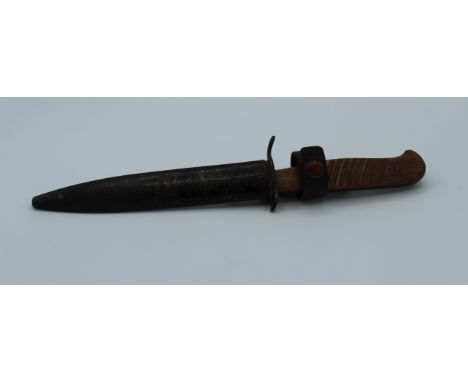 A First War German trench dagger with wood grip and metal sheath. Blade length 14.5cm
