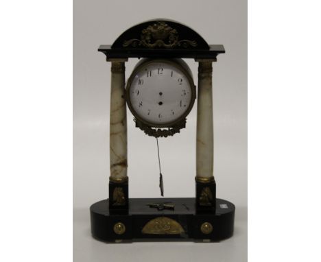 A 19th century French ebonized wood, gilt metal mounted drum case mantle clock with twin alabaster columns and enamel dial. 5