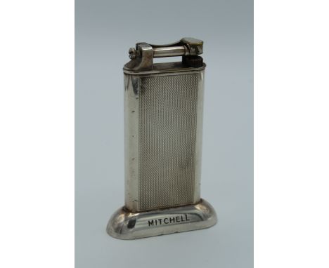 A silver plated Dunhill table lighter with engine turned decoration, named Mitehell, 1 Bedford Square. 10.5cm high&nbsp;