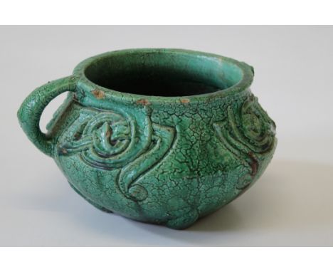 Archibald Knox for Liberty and Co, a textured green glazed stoneware jardiniere with Celtic knot decoration  One handle lost,