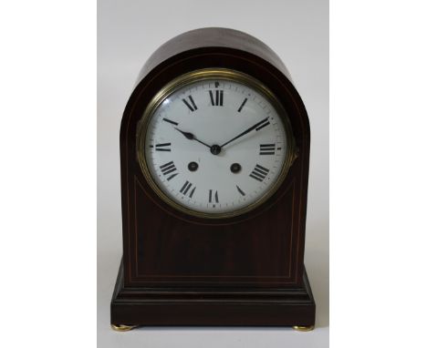 An Edwardian mahogany, inlaid and line inlaid mantel clock, having an enamel dial in an arched case