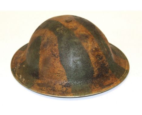 A WWII British helmet with bi-colour sand applied camouflage, leather lining and chin strap&nbsp;