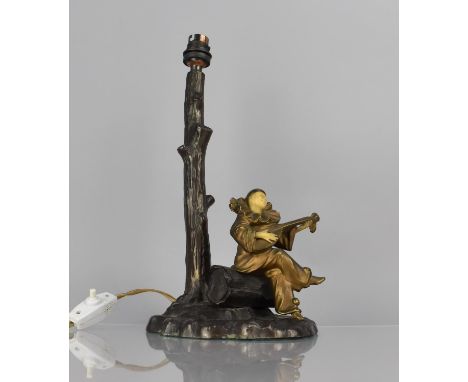 After Chiparus, A Bronze Figural Table Lamp Base in the form of Clown Playing Lute Under Tree, 34cms High Max 