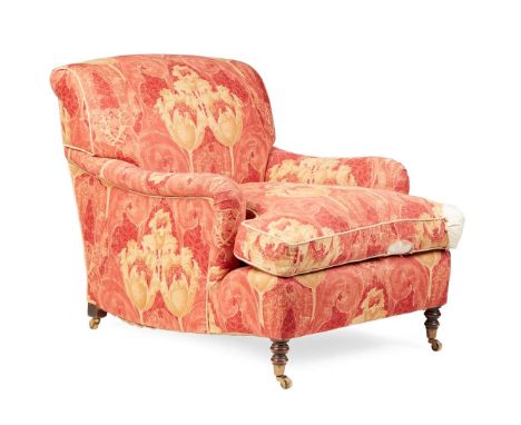  20TH CENTURY in the Howard & Sons style, the low square back above a loose cushion seat and low scrolled arms, raised on tur