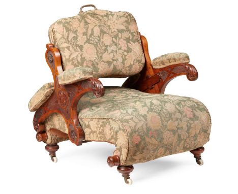  19TH CENTURY the padded swivel back on a pivoting arm mechanism with a foliate and flowerhead carved frame, above a deep stu