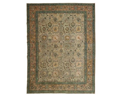  NORTHWEST PERSIA, MID 20TH CENTURY the cream field with allover palmette and scrolling vine pattern, within light pink borde